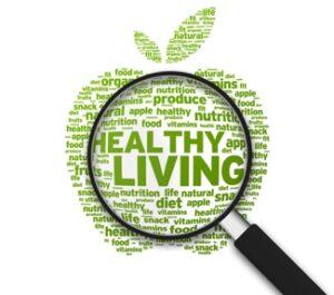 apple graphic made up of words. magnifying glass focused on words "healthy living"